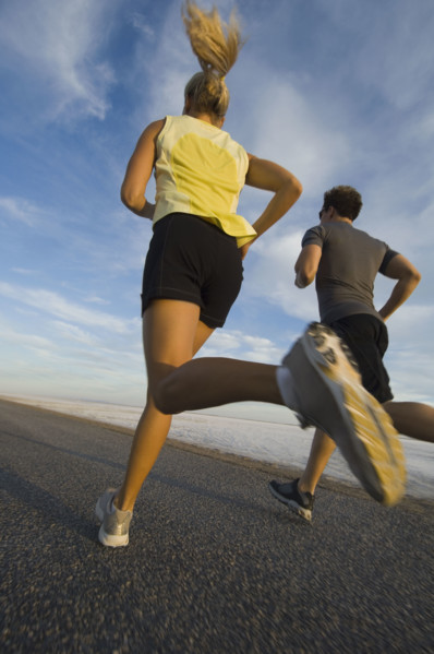 Couple running on road, Utah, United States. Date : 2007