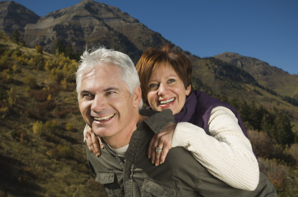 Senior man giving wife piggy back ride, Utah, United States. Date : 2007
