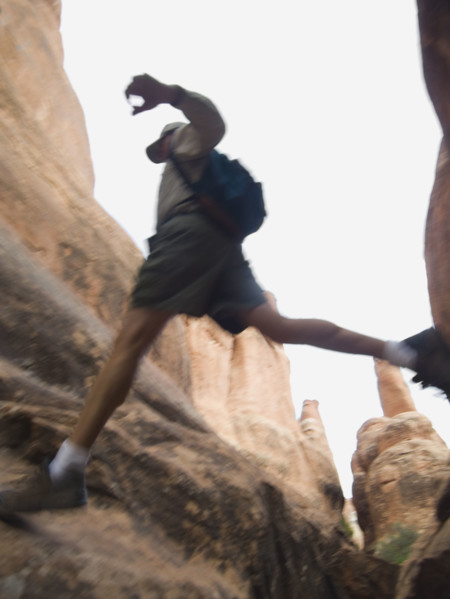 Man jumping over rock formations. Date : 2007