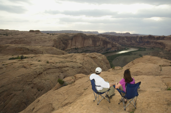 Couple in camping chairs over-looking canyon. Date : 2007