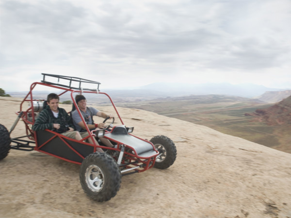 People in off-road vehicle on rock formation. Date : 2007