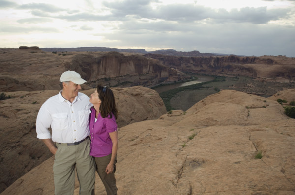 Couple smiling at each other on rock formation. Date : 2007