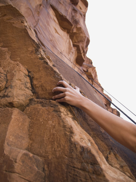 Close up of woman’s arm rock climbing. Date : 2007