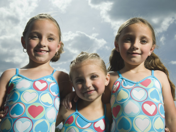 Three young sisters hugging. Date : 2007