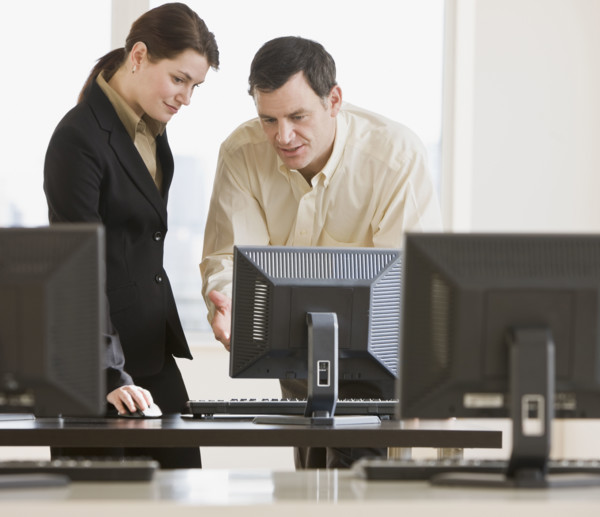 Businesspeople looking at computer.