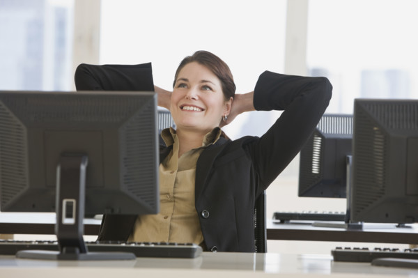 Businesswoman with hands behind head.