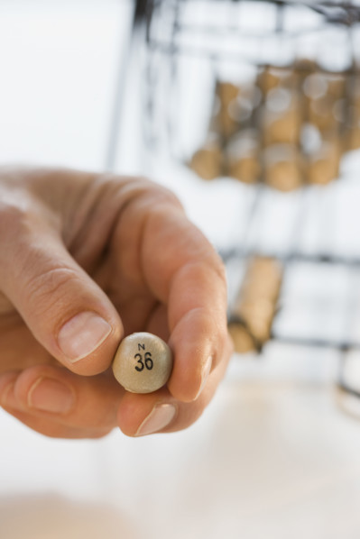 Man holding bingo ball.