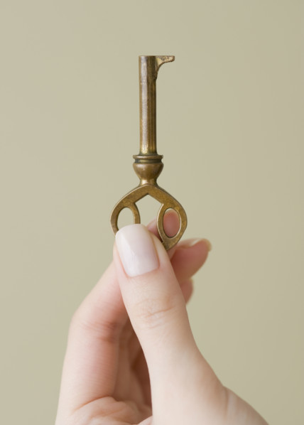 Woman holding old fashioned key.