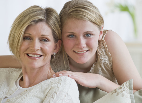 Mother and daughter hugging.