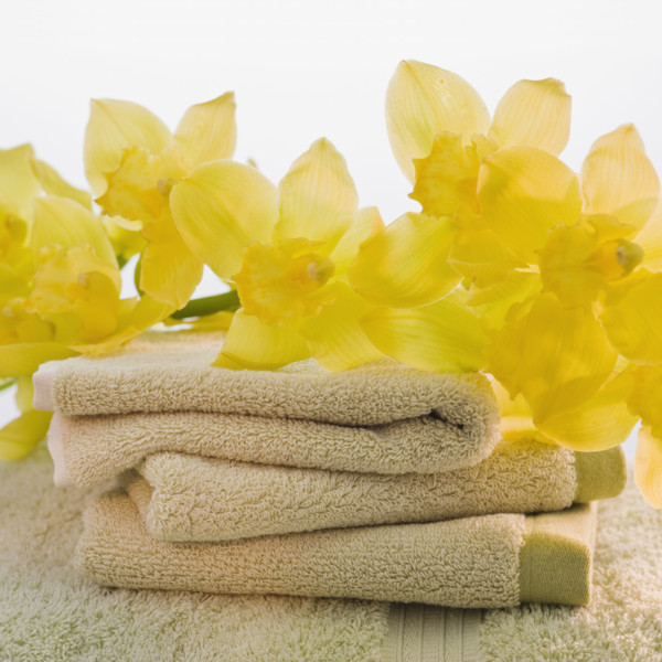 Flowers on stack of towels.