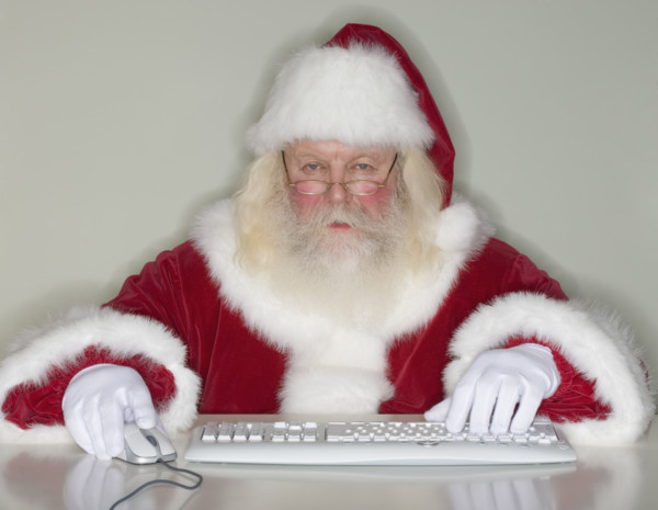 Santa Claus typing on computer.