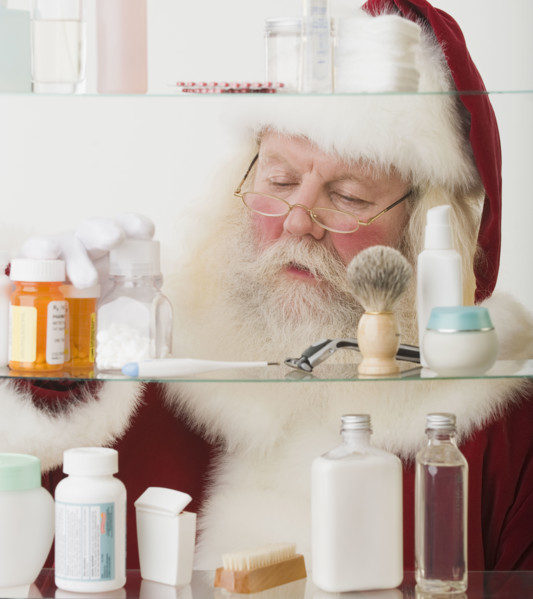 Santa Claus looking in medicine cabinet.
