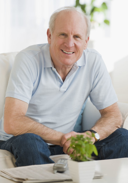 Senior man sitting on sofa.