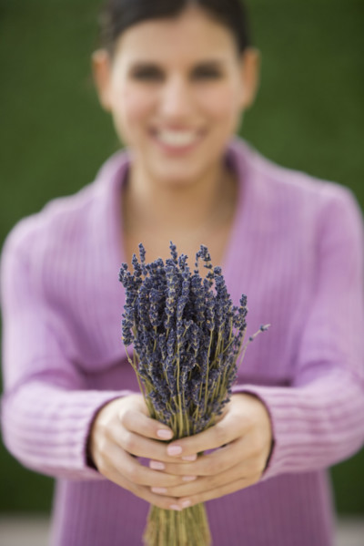 Woman holding bunch of lavender.