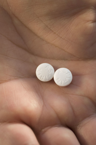 Close up of medication in man’s hand.