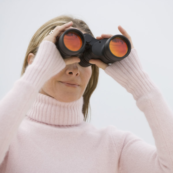 Woman looking through binoculars.