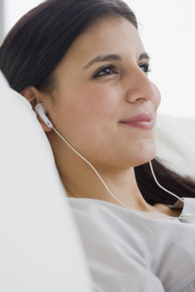 Woman listening to mp3 player.