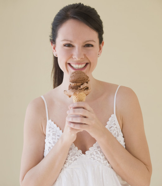 Woman eating ice cream cone.