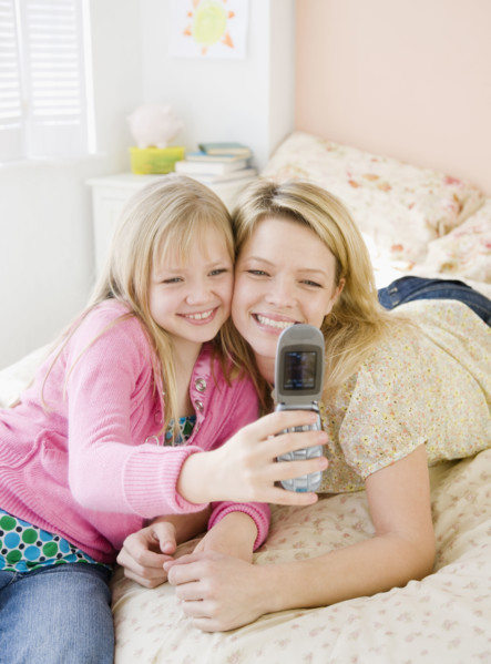 Mother and daughter taking own photograph. Date : 2008