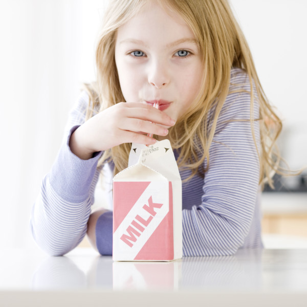 Girl drinking carton of milk. Date : 2008