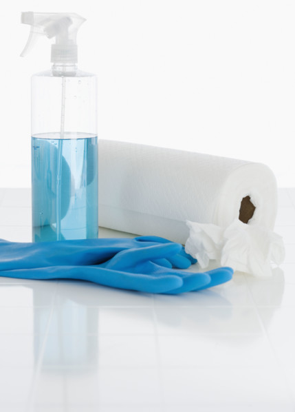 Rubber gloves and cleaning solution next to paper towels. Date : 2008