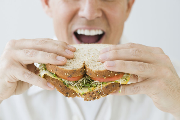 Man eating sandwich.
