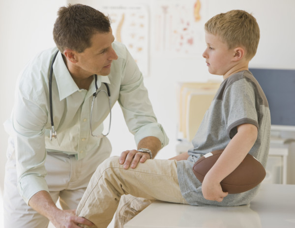 Male doctor examining boy.