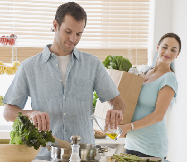 Hispanic couple preparing food.
