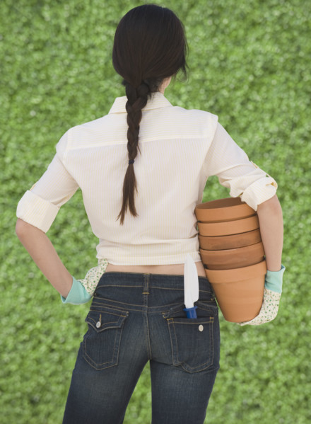 Woman holding terra cotta pots.