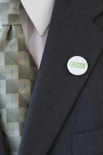 Eco-friendly button on businessman’s lapel.