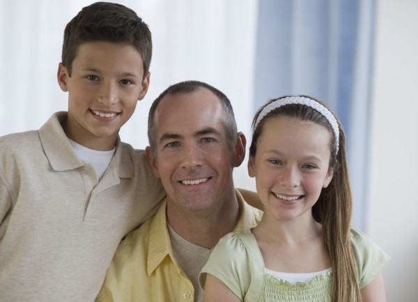 Father and children hugging.