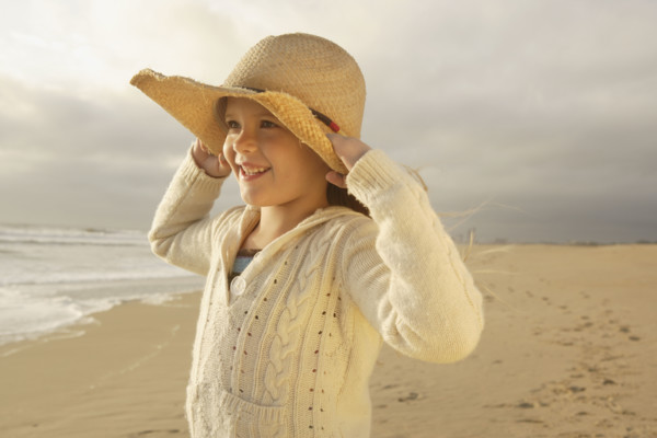 Girl wearing hat at beach. Date : 2008
