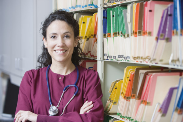 Female doctor next to charts. Date : 2008