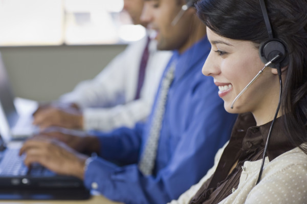 Multi-ethnic businesspeople wearing headsets. Date : 2008
