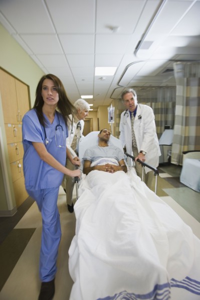 African man being wheeled in hospital gurney. Date : 2008