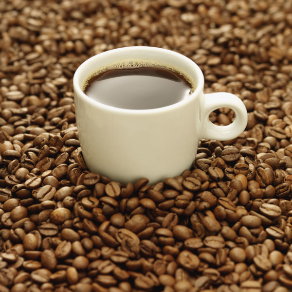 Cup of coffee surrounded by coffee beans. Date : 2008