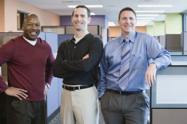Multi-ethnic businessmen standing in office. Date : 2008