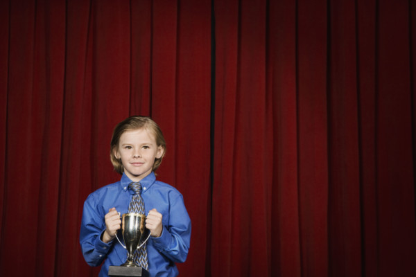 Boy holding trophy on stage. Date : 2008