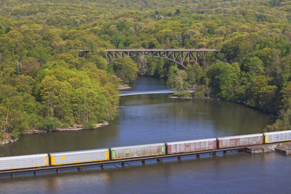 Cargo train on rail over river, New York, United States. Date : 2008