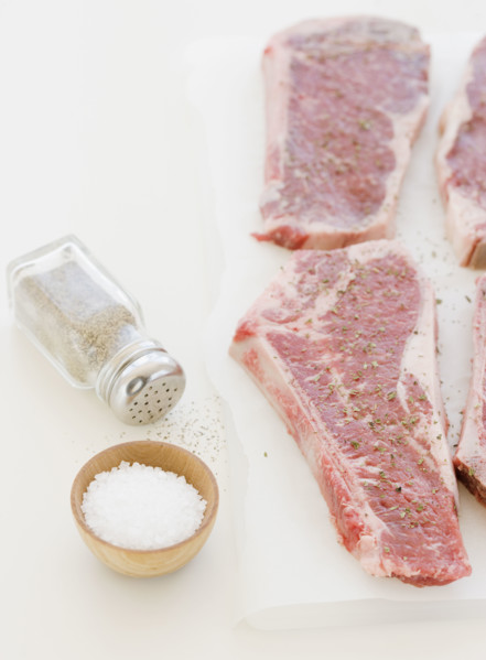 Close up of raw steaks and seasoning. Date : 2008