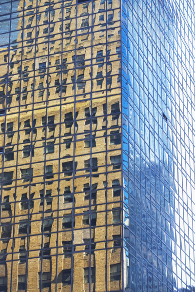 Old building reflected in modern building windows. Date : 2008