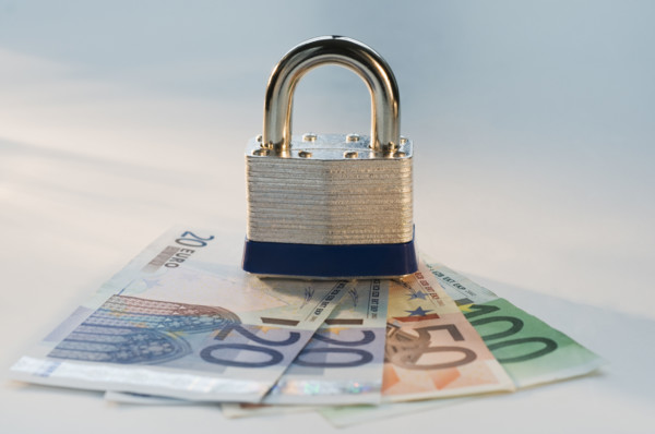 Close up lock and paper euros. Date : 2008