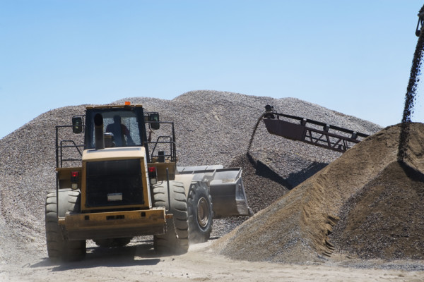 Bucket loader moving pile of gravel. Date : 2008