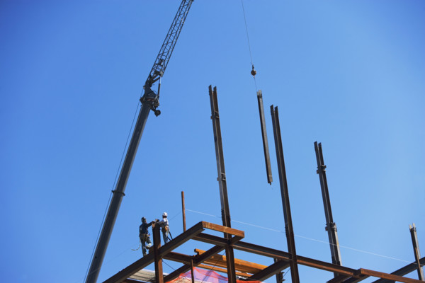 Low angle view of construction workers on beam. Date : 2008
