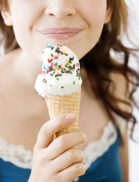 Teenage girl eating ice cream cone. Date : 2008