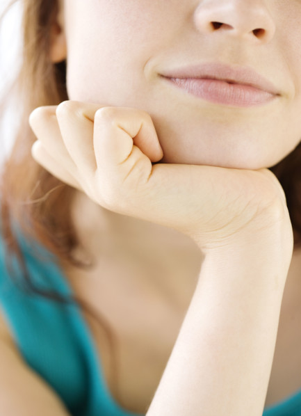 Close up of teenage girl resting head in hand. Date : 2008