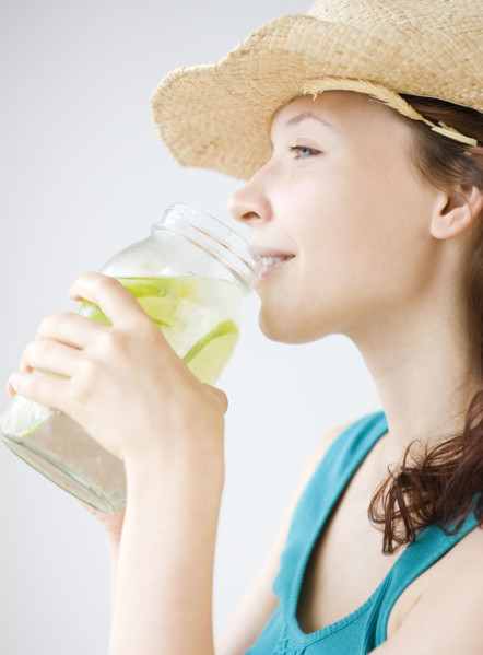 Teenage girl drinking refreshing lime water. Date : 2008