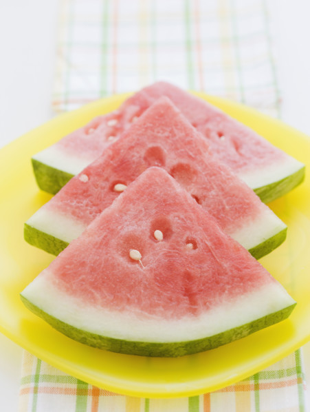 Sliced watermelon stacked in a row. Date : 2008