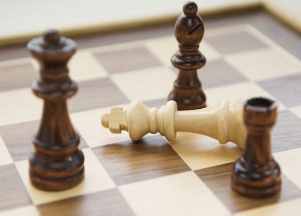 Chess pieces surrounding fallen king. Date : 2008