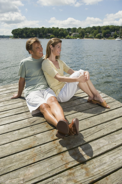 Couple sitting on dock.